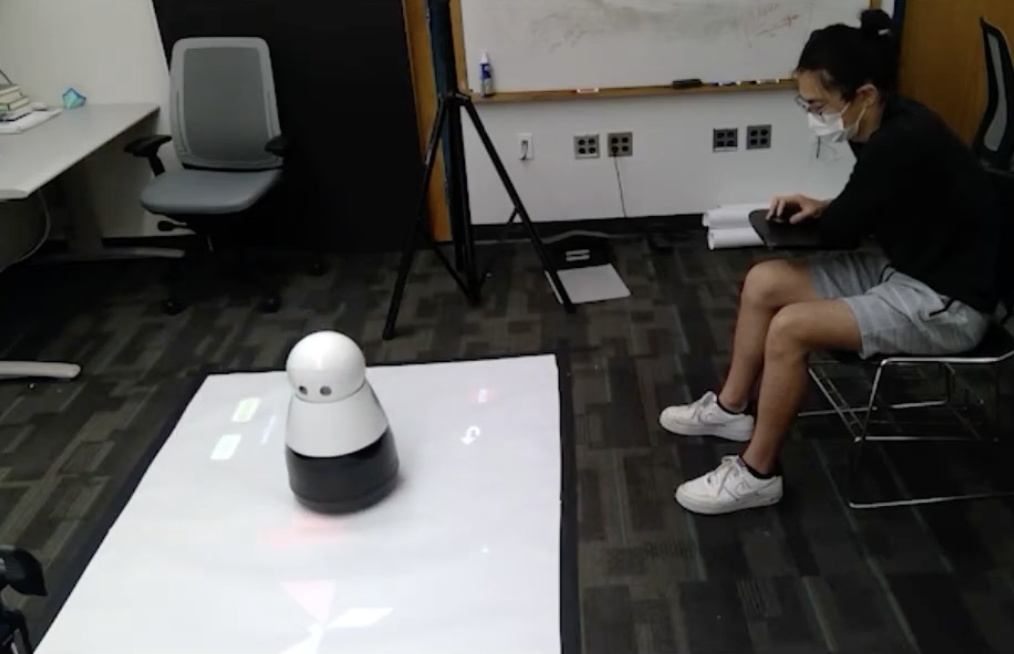 An gif animation where a human and a robot take turns to create a tangram.